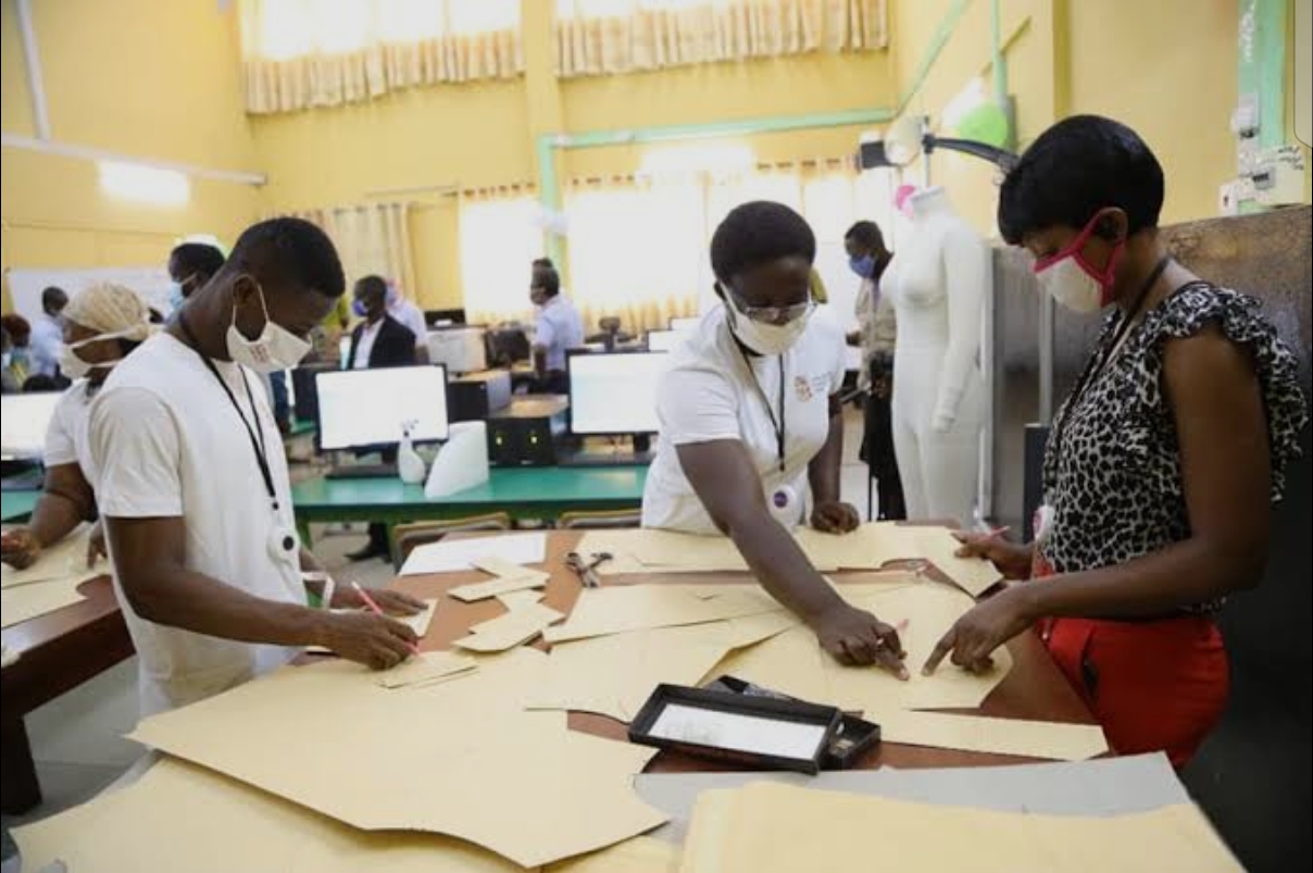 Trainees cutting fabric patterns at an EP Africa inclusive fashion training workshop